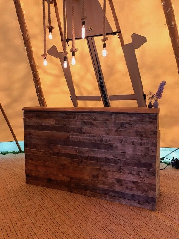 Rustic Bar with rope lights above. The lights look amazing but also add additional lighting for your bar team and guests