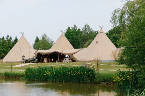 three giant hat tipis at lakeside venue in derbyshire