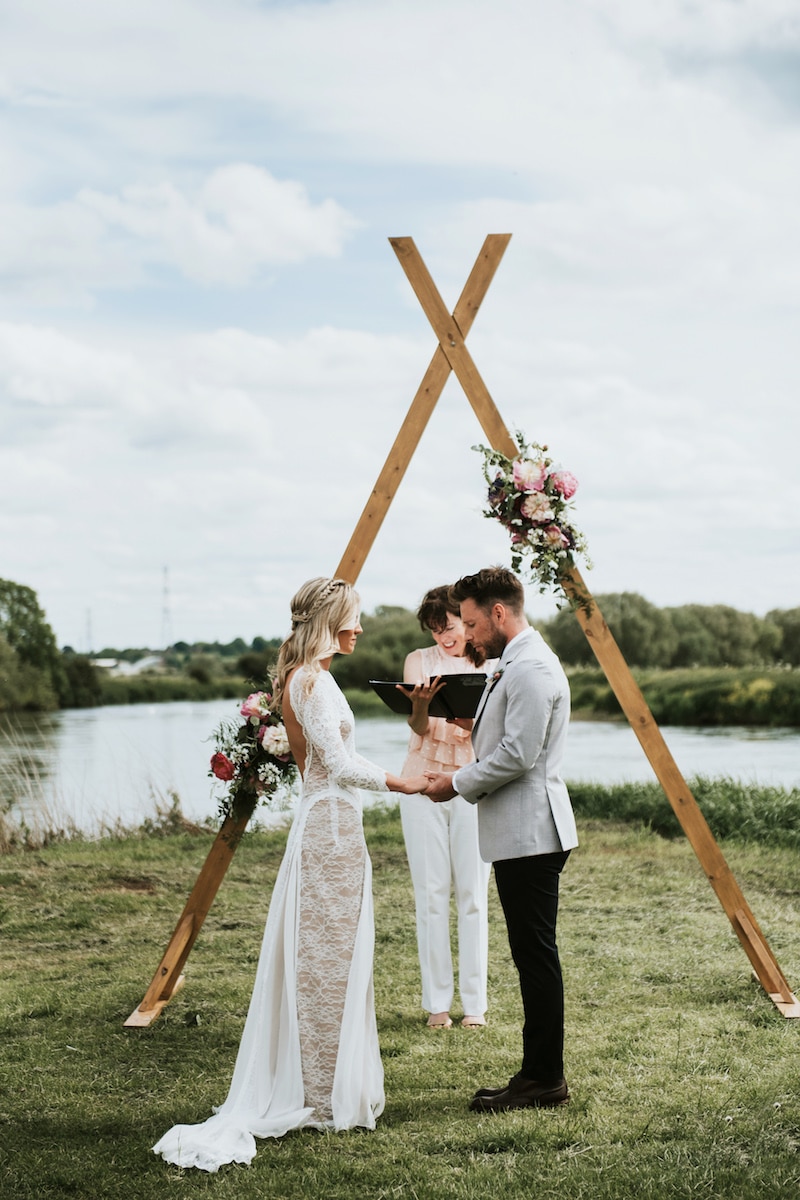 Waterfront Ceremony conducted by Jo from My perfect ceremony in front of Tipi Arch completed with florals. Cuttle Brook in Derbyshire is a waterfront wedding venue