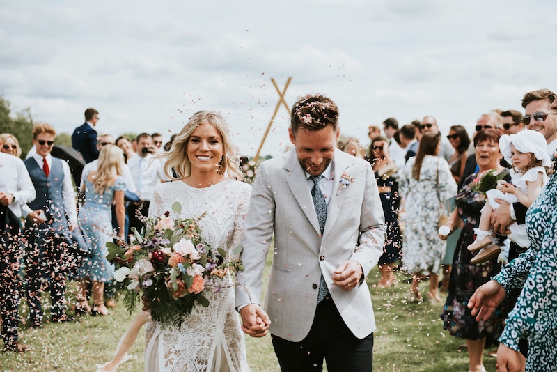 confetti throwing at Cuttle Brook with biodegradable floral petals. Cuttle Brook is a waterfront wedding venue in Derbyshire offering relaxed celebrations 