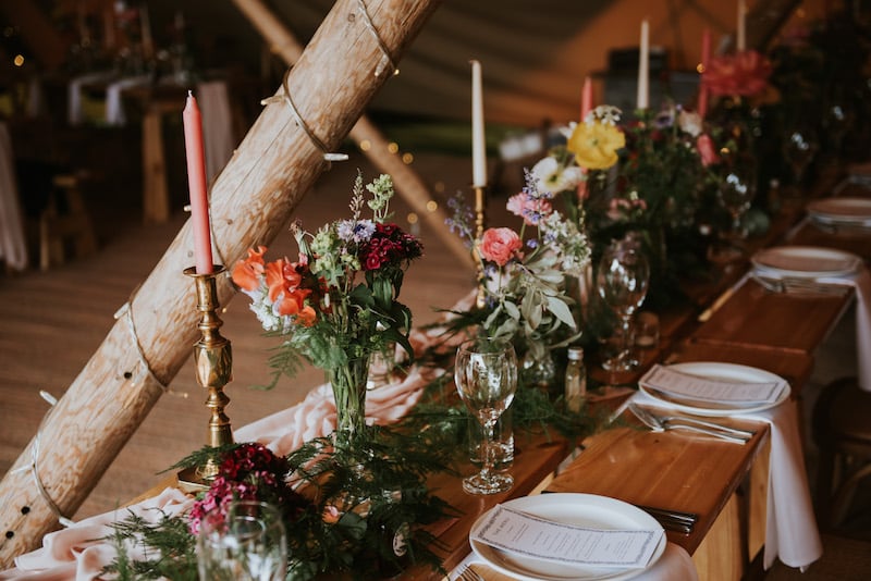 Tipi Table setup with florals, plates and menus