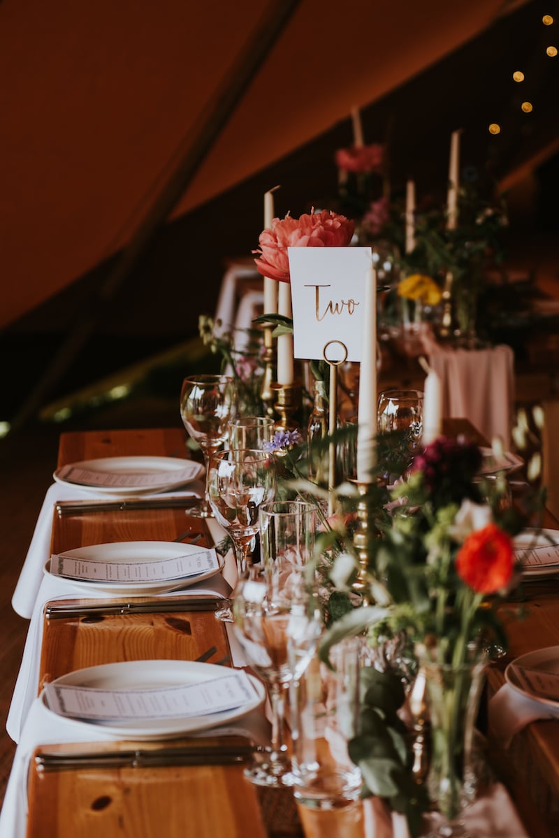 Tipi Table setup complete with candles, florals and waterfall napkins