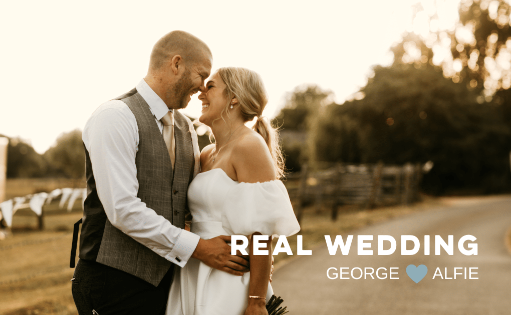 Happy married couple, looking at each other and smiling, groom has his arms around the bride. Sun is setting in the background
