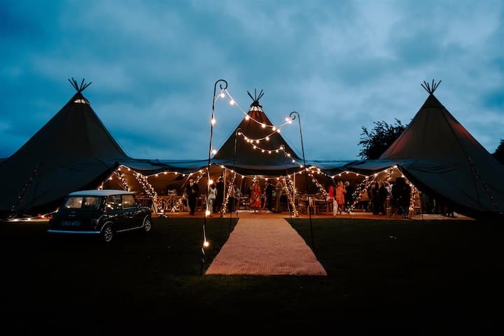 Three Giant Hat Tipis at Night